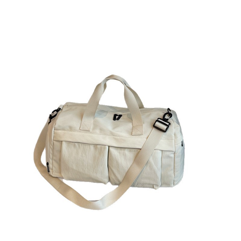 Nueva bolsa de viaje portátil simple y versátil, bolsa de equipaje de gran capacidad para mujeres, bolsa deportiva leve y casual de alta calidad.