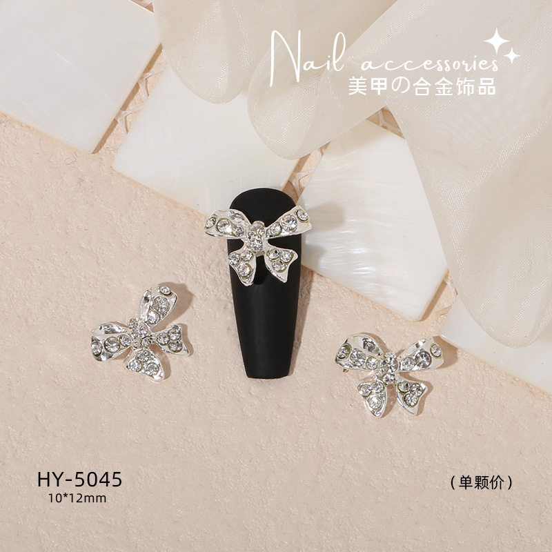 Nuevo arco de uñas amor aleación decoración de uñas flor de la luna mariposa clavo taladro fábrica joyería al por mayor