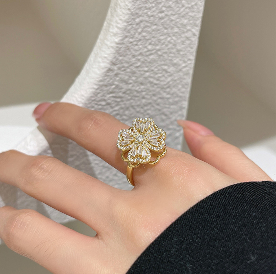 Anillo giratorio de circonita microincrustada con diseño de flor de cuatro hojas, anillo ajustable, flor giratoria tipo molino de viento, estilo fresco para mujer, superventas transfronterizo