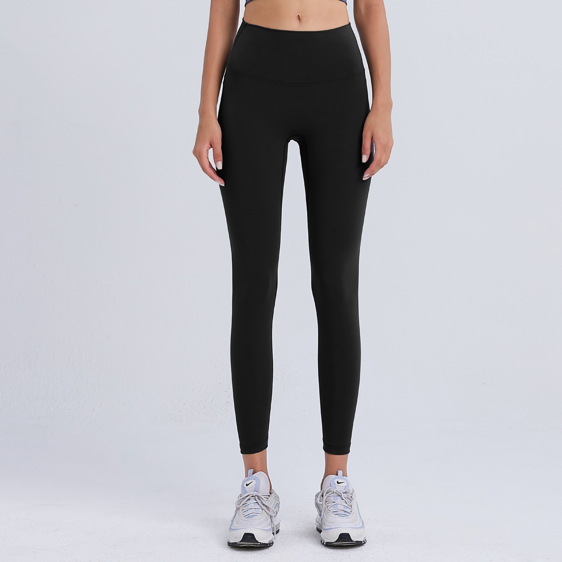 気まずい線の9分のズボンの高弾力のヨガのズボンのレギンスの女性の美のヒップのズボンのやせている腰はやせている運動のタイツを現します