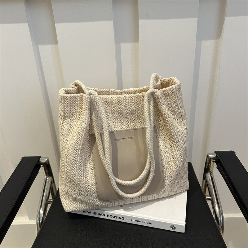 Bolsa de tejido de gran capacidad para mujeres 2024 nueva moda bolso de hombro de aire extranjero de alta calidad sensación de tela de paja bolso de mujer bolso especial