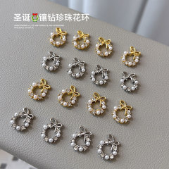 新しいクリスマスの花輪のネイルアクセサリーの蝶結びの真珠の合金はダイヤモンドのクリスマスの花輪の爪のフラッシュドリルの卸売りを入れます。