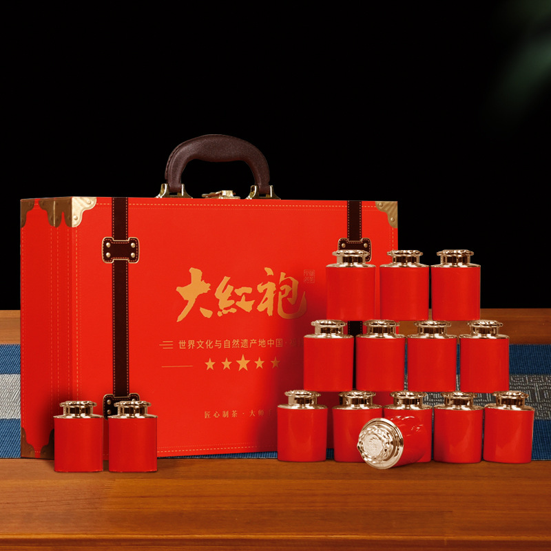 赤い服のお茶のギフトボックスの小さい缶のウーロン茶の高級なスーツケースは新年の祝日にお茶をプレゼントして自分で飲みます。