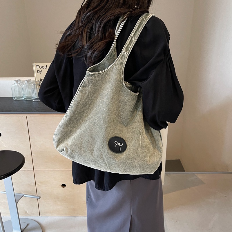 Bolso de viaje retro de mezclilla de alta gama, bolso de viaje de marca de moda de moda femenina, bolso de axila de hombro simple y casual de gran capacidad