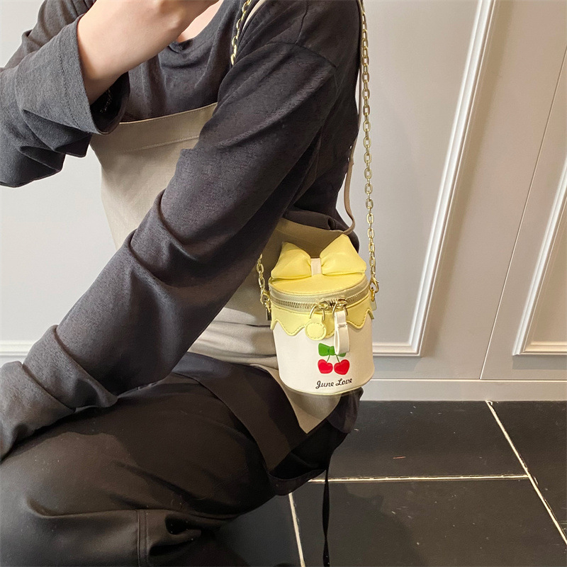 Bolso de cubo lindo japonés 2025 primavera y verano nuevo bolso femenino lindo lazo bolso de hombro mini cadena bolso de mensajero