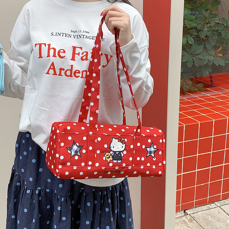 Retro polka dot cylindrical handbag, featuring fun cartoon appliqués, perfect for everyday use and creating a casual, stylish look