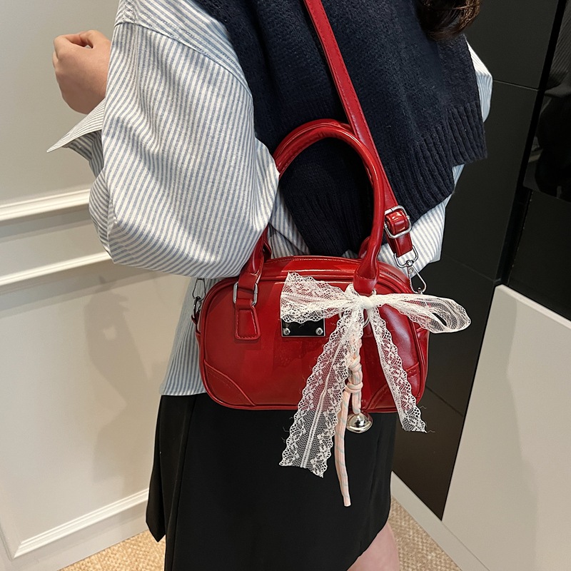 Bolsa de bolos portátil coreana de nicho para mujeres 2026 nueva textura mochila de hombro de estilo extranjero para viajar simple