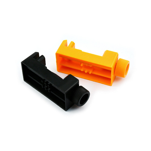 Orange plastic mini watch strap remover tool for adjusting strap length, clock repair tool