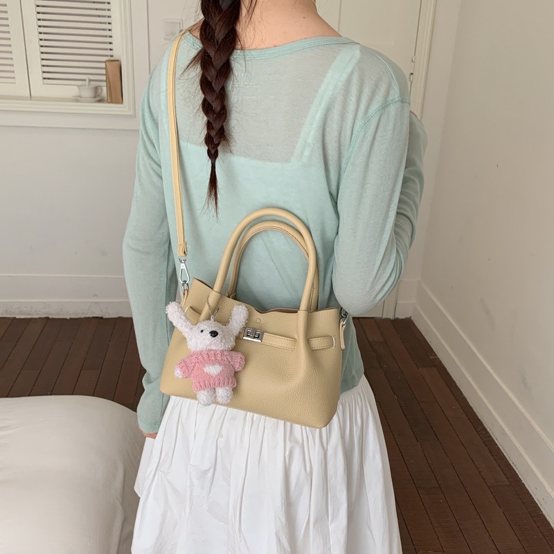 Simple portátil 2026 diseño de bolso de hombro único versátil estilo coreano de transporte de moda nuevo bolso de cubo nicho femenino