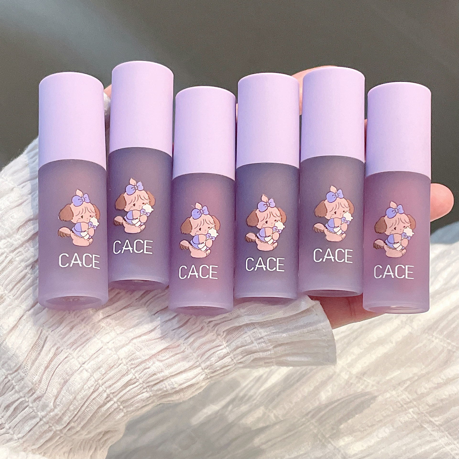 CACE Little Cute Dog Velvet Lip Gloss is available in six colors for long-lasting makeup. It is a versatile new product with a matte lip gloss that can be used for color and whitening. Wholesale undefined