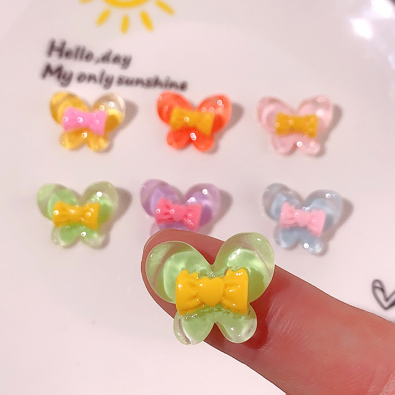 Nuevo color transparente mariposa arco DIY accesorios de resina pegamento crema caja de teléfono móvil adornamiento de pelo agujero material de parche de zapatos agujero
