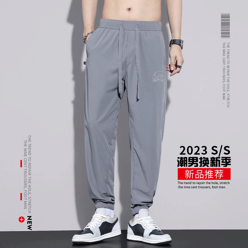 Pantalones de nueve puntos deportivos de secado rápido de estilo fino de verano, pantalones harem huecos, marca de moda para hombres, malla suelta, seda de hielo casual