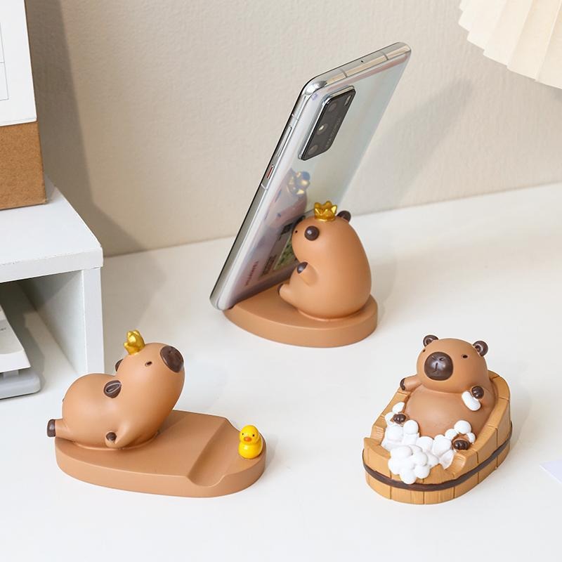 Dibujos animados linda celebridad de Internet Kapibala soporte para teléfono móvil decoración escritorio de oficina estación perezosa soporte plano artefacto