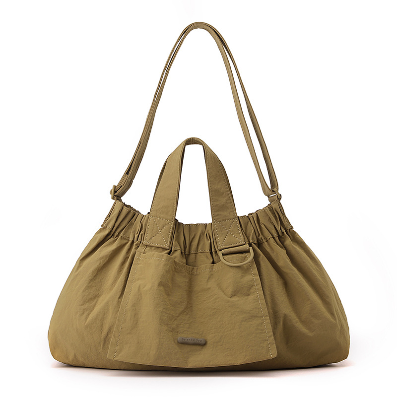 El nuevo diseño de nicho coreano del comercio exterior tiene un sentido del conocimiento de embarque a mano y una bolsa de mujer en el hombro es ligera, casual y plegable.