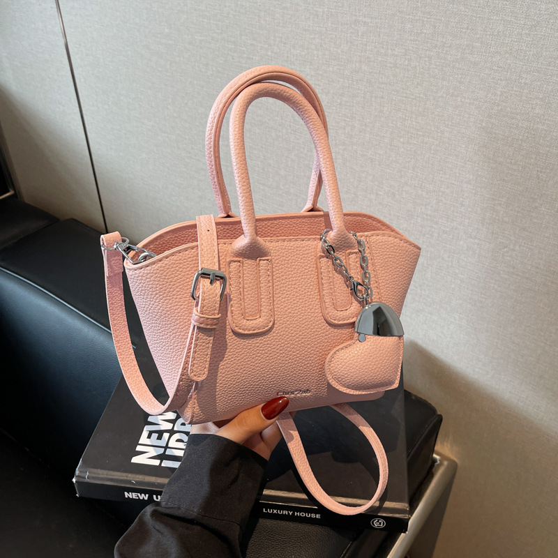 Bolso de cubo portátil de estilo caliente de moda para mujer 2025 nuevo bolso de hombro retro de nicho bolso de mensajero de moda de todo fósforo de moda