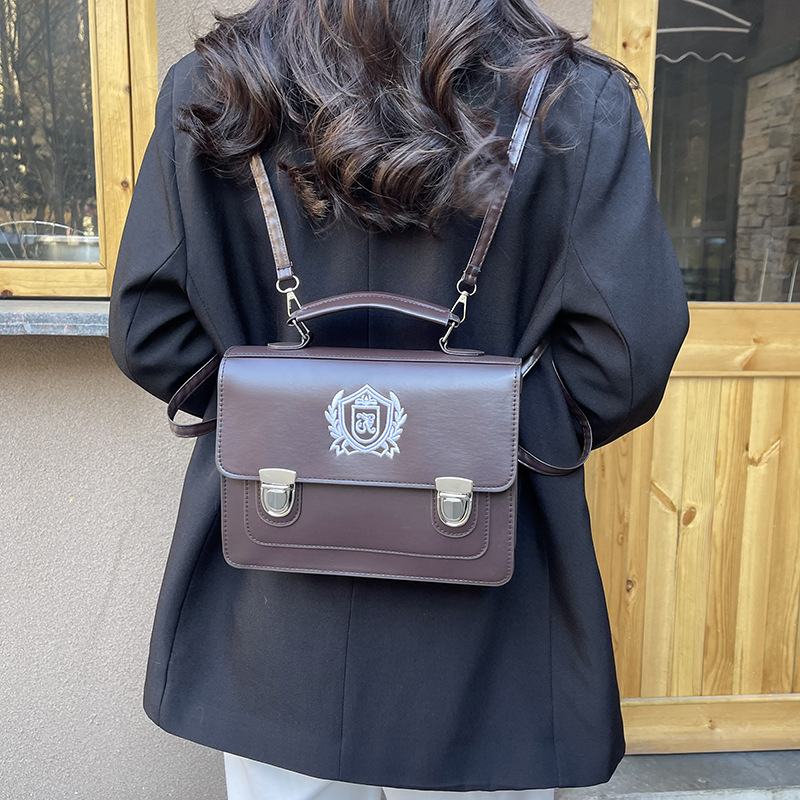 2025 nueva mochila de estilo universitario británico de estilo occidental, mochila de cartero de gran capacidad, bolso de mensajero de un solo hombro