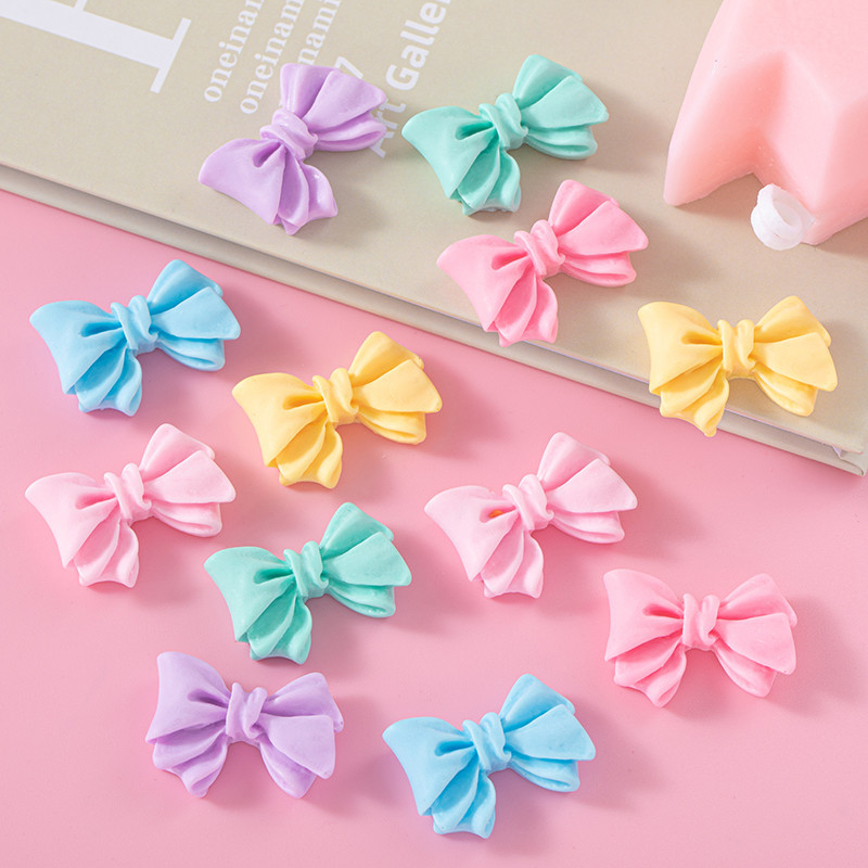 Accesorios de resina de arco de color macaron DIY Crema Accesorios de cuerda de cabello de agujero de caja de teléfono móvil Colgante de hebilla de zapato