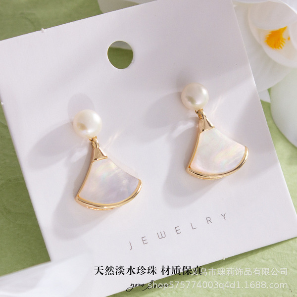 Organic earrings from pearl with bow heart shaped with tassels