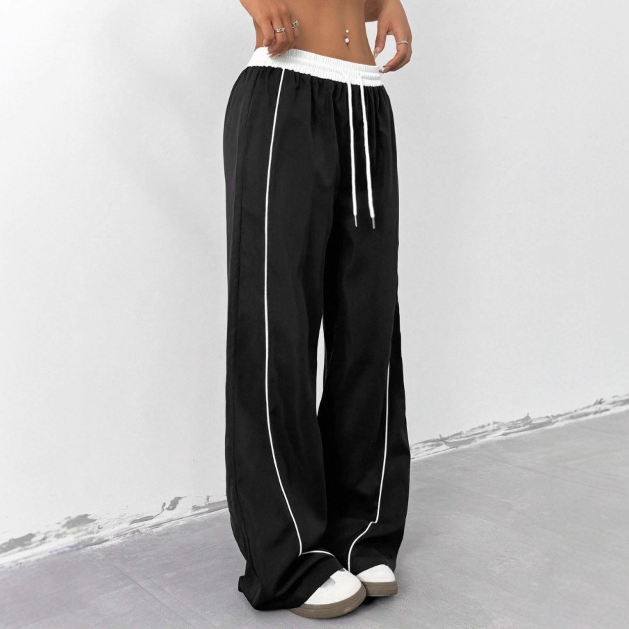Europa y los Estados Unidos transfronterizos de otoño y invierno 2025 moda nuevos pantalones deportivos negros de mujer sueltos ociosos nichos de piernas largas