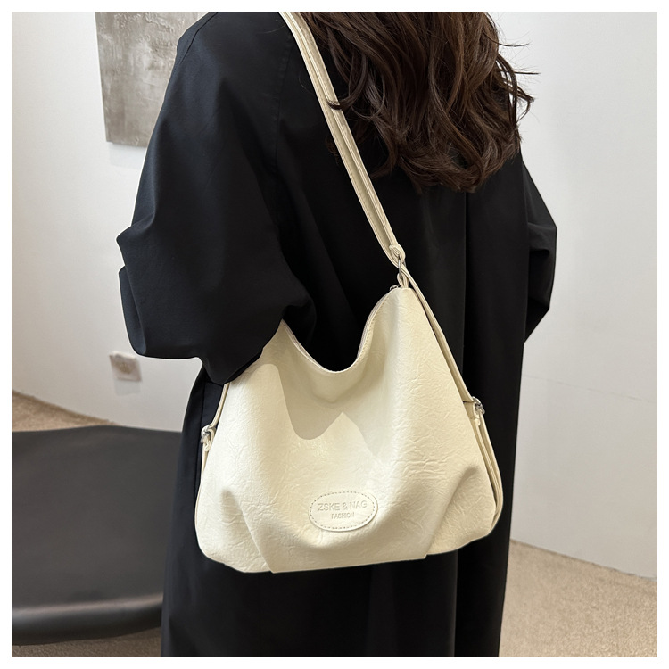 The 2024 new pleated tote bag is a large-capacity casual and fashionable backpack for women, featuring multi-functional texture and a single-shoulder crossbody bag undefined