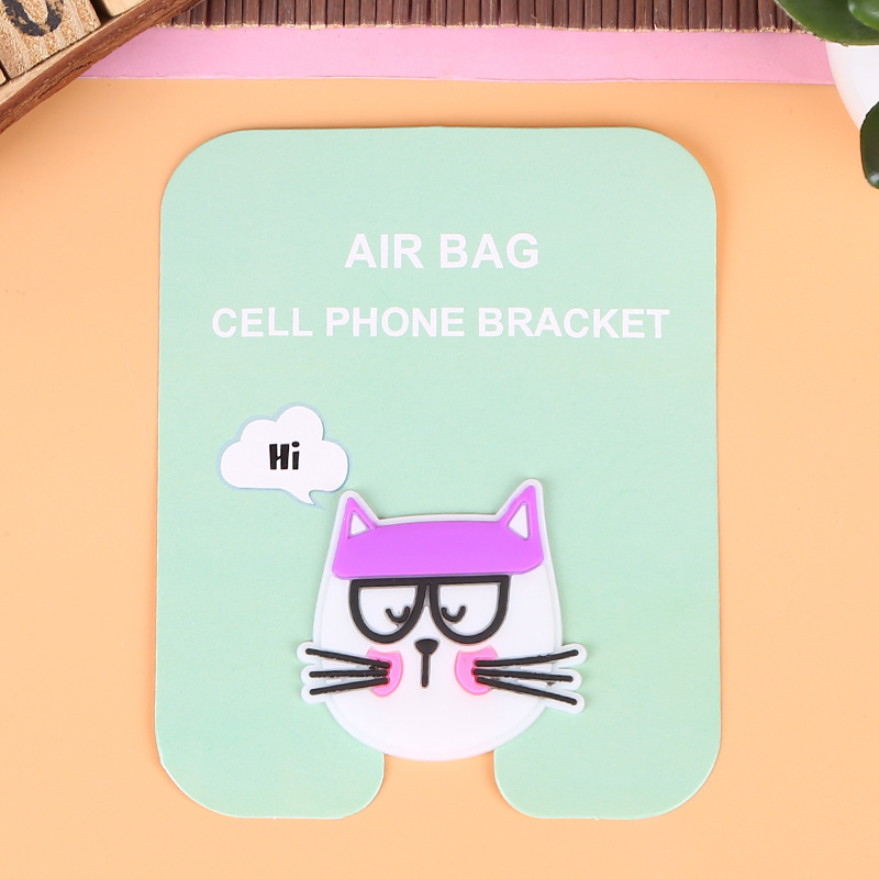 En stock al por mayor TikTok Cartoon creativo soporte de teléfono móvil puede soportar airbag soporte de teléfono móvil soporte de escritorio