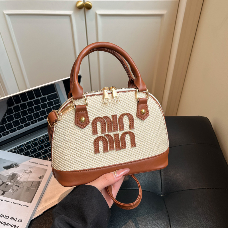 Tendencia transfronteriza coreana bolso de mano conchas bolso de mujer 2026 primavera nuevo empalme color bolso de hombro bolso de viaje