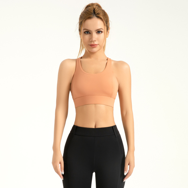 Área transfronteriza agujero sensación yoga sujetador trasero respirable botón de alta resistencia a prueba de choques ropa interior deportiva