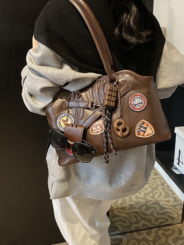 Insignia retro de gran capacidad hombro brazo bolso para mujeres 2025 nueva moda transfronteriza alta textura bolso