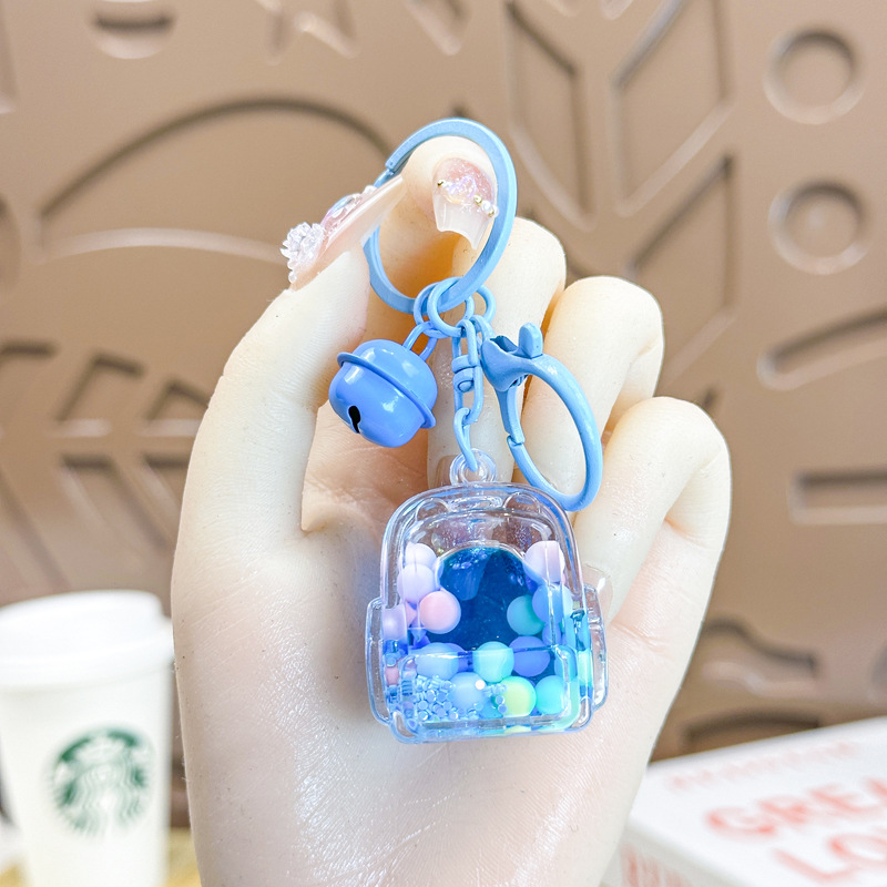Caricatura en aceite líquido arena flotante botella mochila llavero delicado colgante accesorios accesorios máquina de muñecas pequeños regalos al por mayor