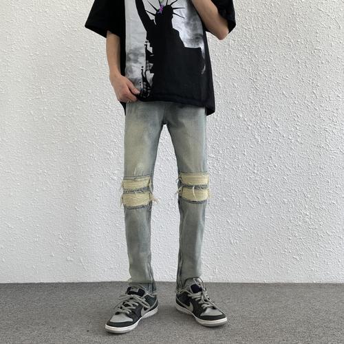 Euro-American trendy high-street light-blue distressed denim jeans for men: vintage-style, slim-fit, tapered legs, with zip-up cuffs—versatile and easy-to-match trousers