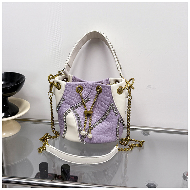 Bolso de cubo de comercio exterior mujer 2026 nuevo nicho transfronterizo ligero de lujo empalmado cadena de diamantes bolso de hombro