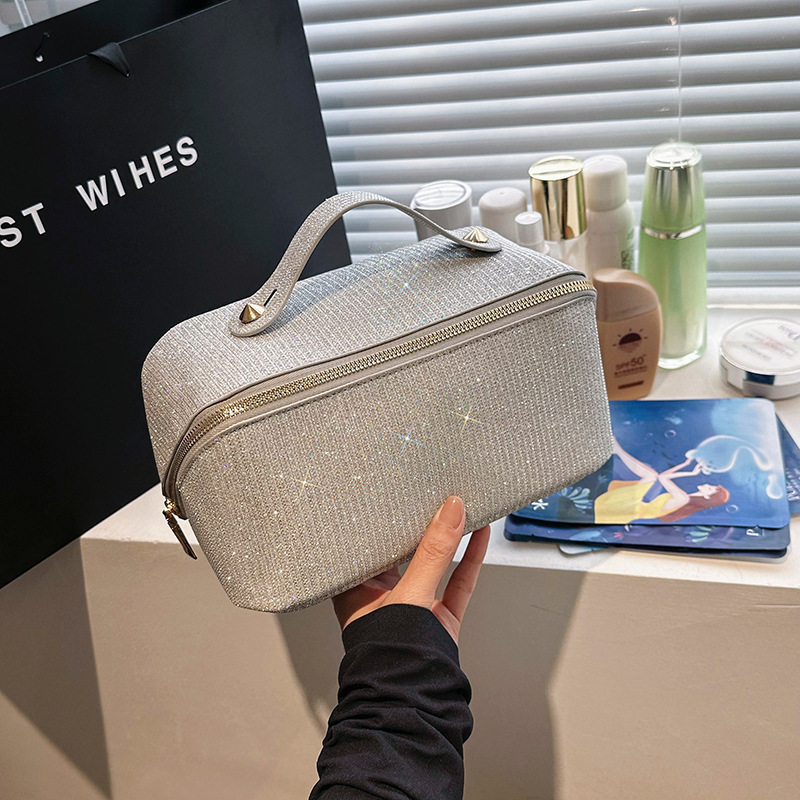 Handheld capacious cosmetic bag with zipper