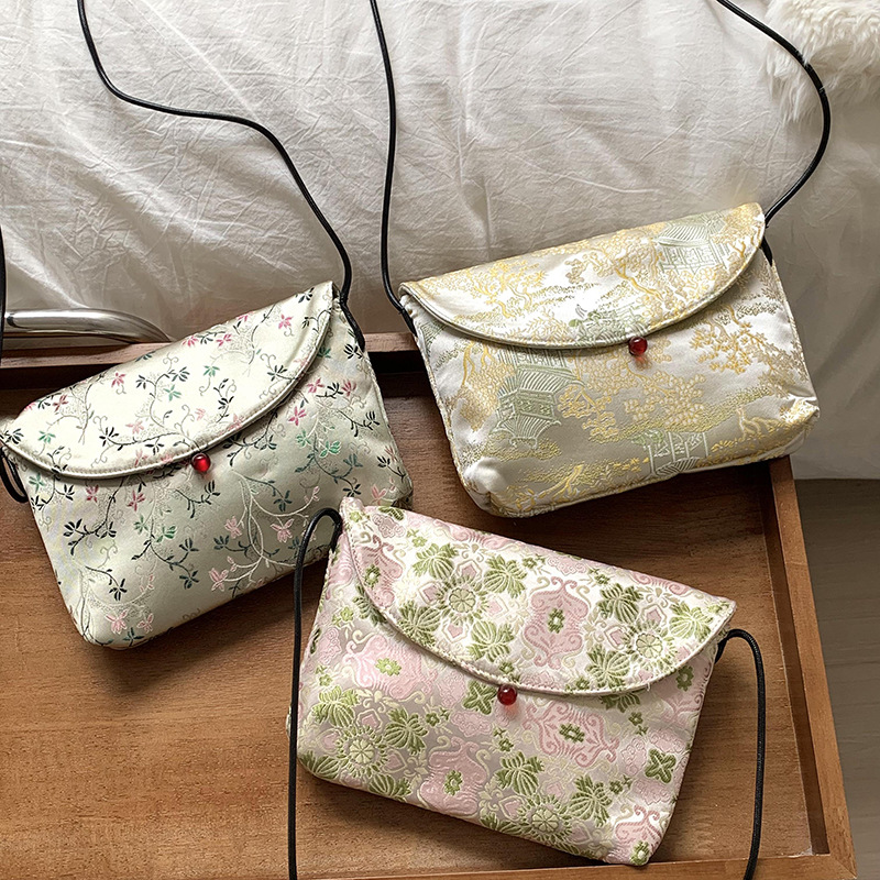 Bolso de mujer alta sensación 2025 nuevo estilo nacional bordado bolso de almacenamiento flor triturada bolsa maquillaje bolso de hombro