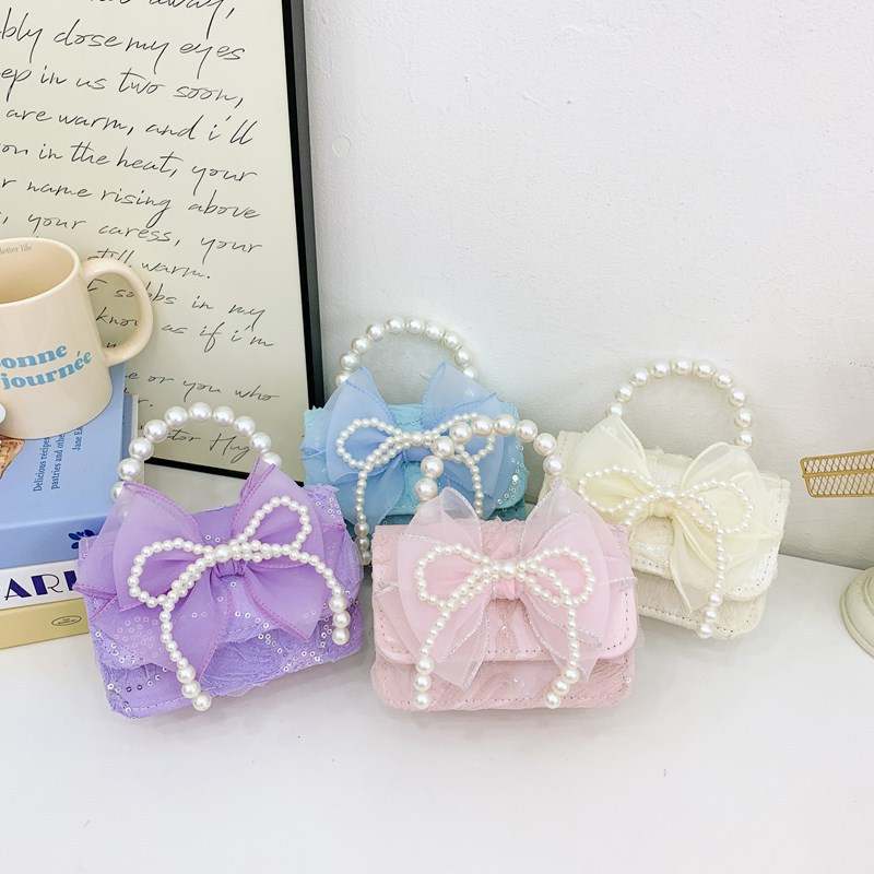 Nueva princesa flor de encaje niñas mochila de hombro de moda perla arco bolso de niños bolso de cambio de dibujos animados