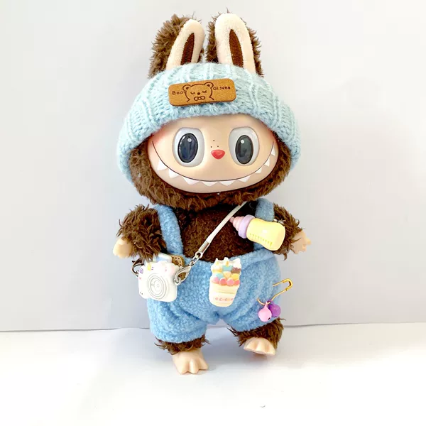 Blue feeding bottle, overall, hat, camera