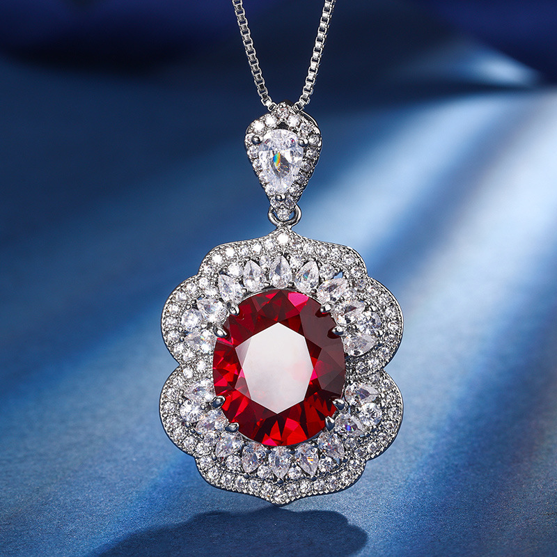 Otoño e invierno Nueva Zhuang Sheng joyería de cobre inferior chapado en oro simulación rojo corindón zafiro azul cristal puntiagudo traje avanzado femenino 12*14