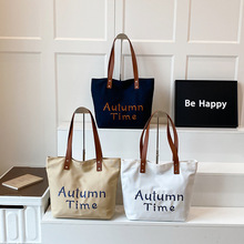 刺绣字母帆布包女2025新款大容量通勤托特包百搭单肩大学生上课包