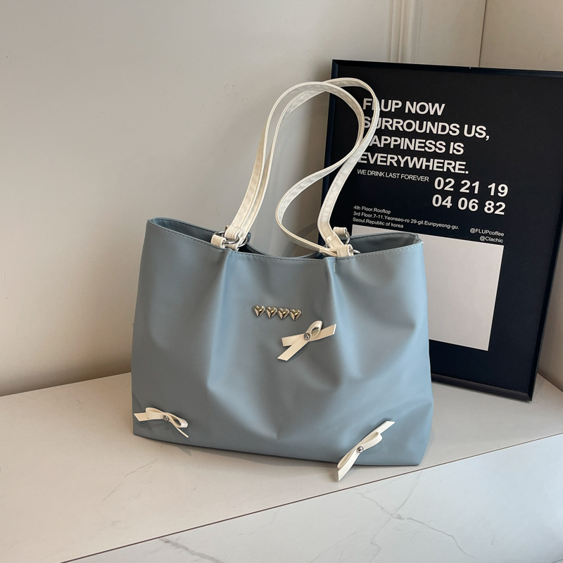 Este año popular bolso de viaje de moda coreana, bolso de hombro de estilo de ballet de mujer, textura alta, arco, bolso de mano.