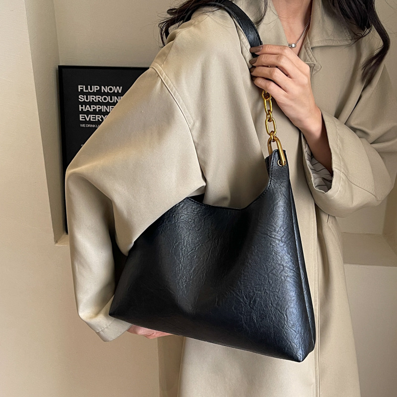 Bolsa de mano relajada coreana para mujeres 2025 nuevo retro versátil viaje bolso de hombro bolso de cubo debajo de la axila