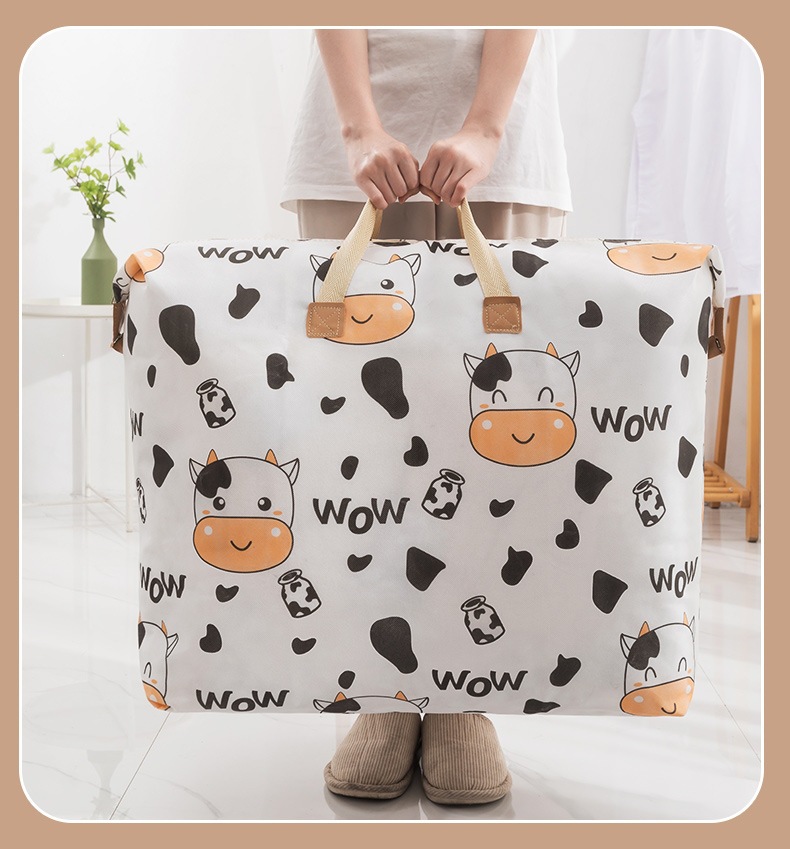 Cartoon Quilt Storage Bag Large Capacity Nonwoven Handheld Moving Packing Bag 85L Cow Print in use
