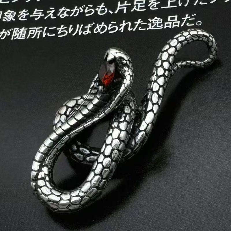 Front view of the S925 sterling silver coiled cobra pendant with a red gem