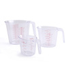 White transparent handheld measuring cup scaled, plastic material, tools set