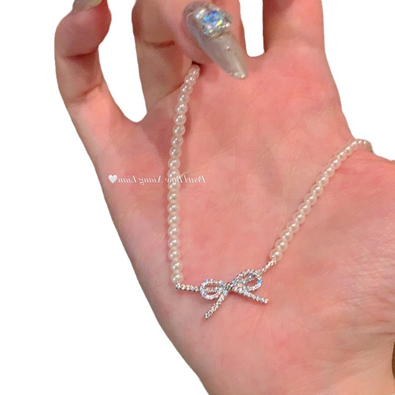 Elegant cute necklace with zircon with bow from pearl