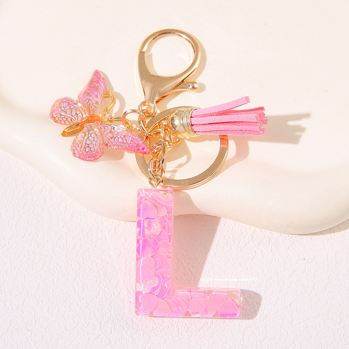 Nuevo rosa damas letras A-Z llavero de goteo de goma sequilla amor letras bordas mariposa llavero transfronterizo