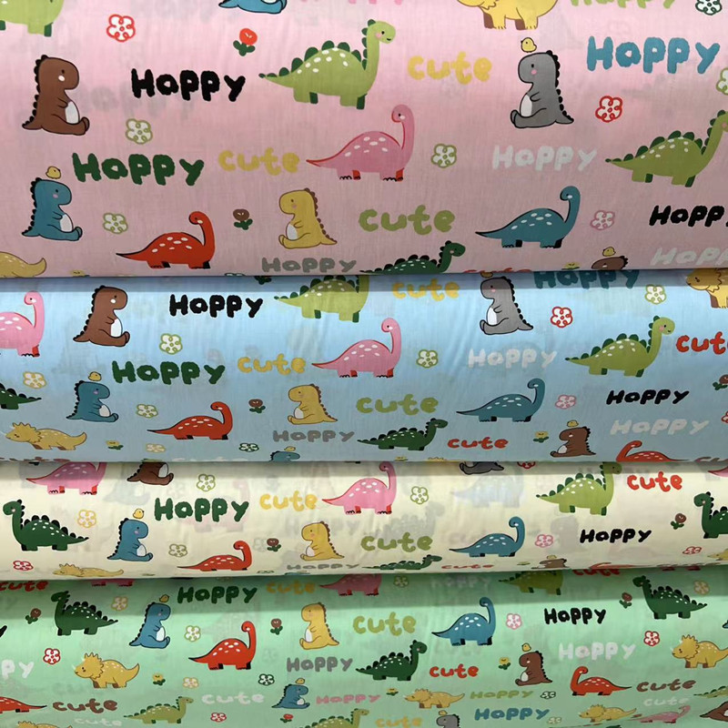 厂家批发 恐龙世界全棉斜纹幼儿园床品卡通 花型服装面料儿童卡通