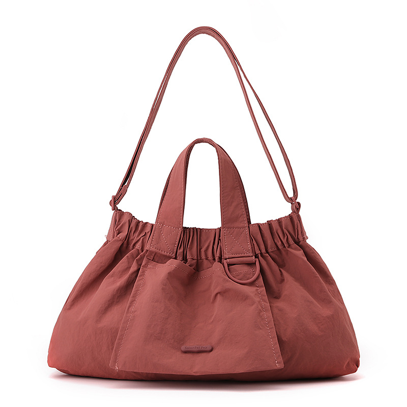 El nuevo diseño de nicho coreano del comercio exterior tiene un sentido del conocimiento de embarque a mano y una bolsa de mujer en el hombro es ligera, casual y plegable.