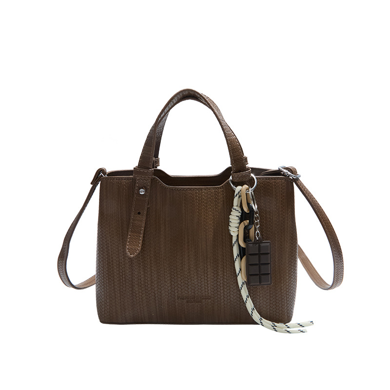 Texturas casuales bolsas de mano para mujeres otoño y invierno 2025 nueva moda simple bolsas de hombro versátiles retro mochila