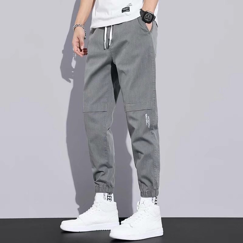 Pantalones de estilo de Hong Kong pantalones casuales de los hombres de estilo japonés de color sólido sueltos monos atados a los tobillos pantalones casuales de los hombres de la marca de moda Pantalones a juego