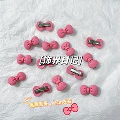 少女のピンクの蝶結びのヘアピン