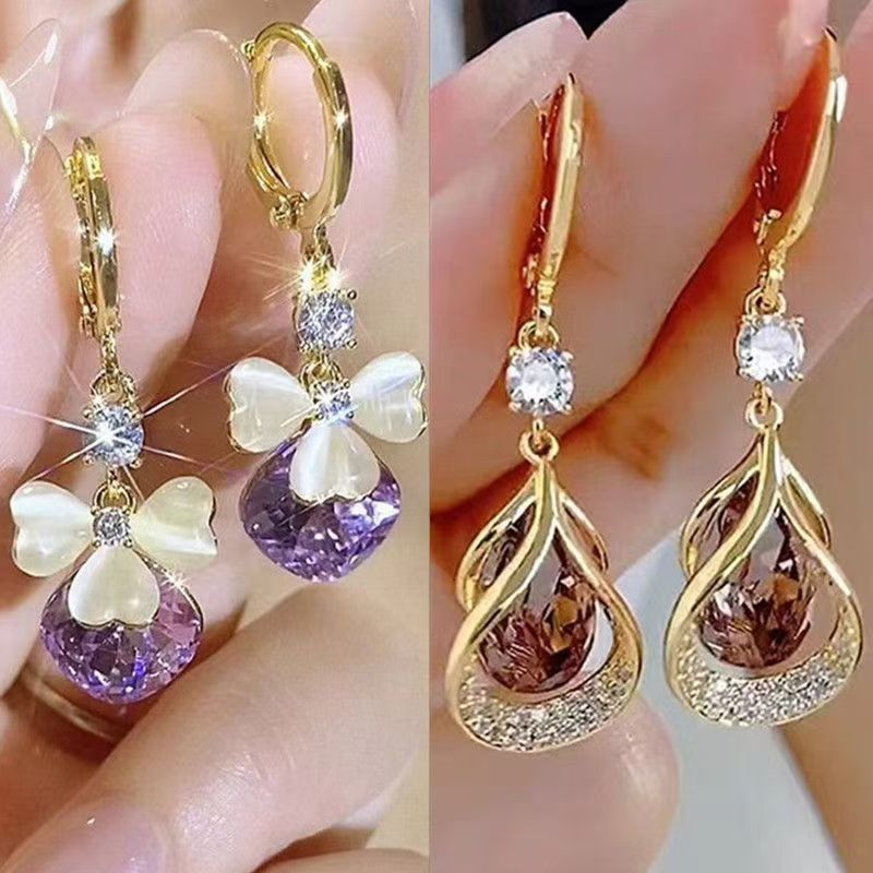 Pendientes de gota de agua morada de pétalo de ópalo de temperamento de lujo ligero, diseño de nicho femenino, moda y todo fósforo